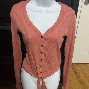 Pink long sleeved button up v-neck shirt